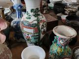 de nombreux vases et bols posés sur la table dans la pièce