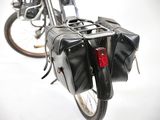 a bike with a bag strapped to the back of it