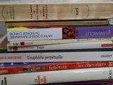 many books stacked on top of each other on a table
