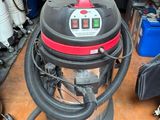 a vacuum that is sitting on the floor in the garage