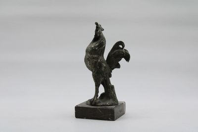 statue of a rooster on a marble base on a white background