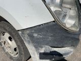 a close up of the front of a car with a denting wheel
