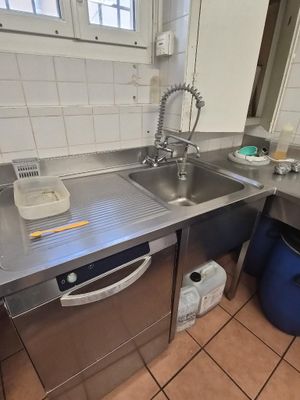 a kitchen with a sink and a dishwasher in it