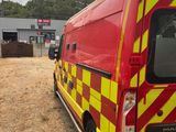a red and yellow van parked on the side of the road