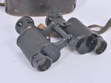 an old pair of binoculars sitting on top of a white surface