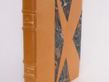 an orange book with a black and white design on the cover