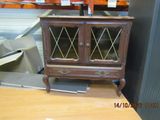 a small wooden cabinet with glass doors on top of a table