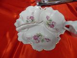 a white plate with purple flowers on it on a red table