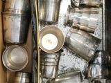 a box full of silver cups and pans in it