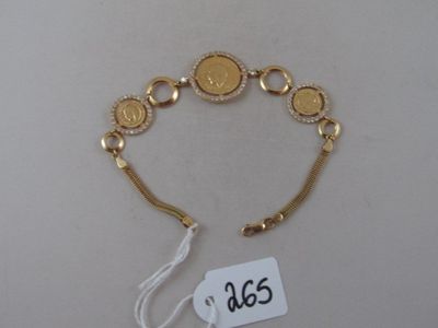 a close up of a gold bracelet with a tag on it