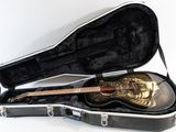 a guitar in a case on a white surface