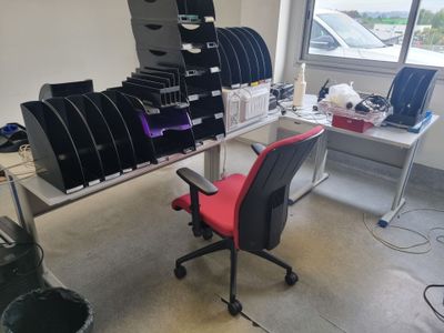a desk with a chair and a computer on it