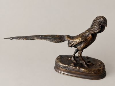 statue of a pheasant on a base on a white background