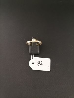 a couple of gold rings sitting on top of a black table