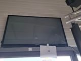 a flat screen tv mounted on the wall above a window
