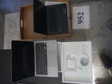 two laptops sitting on top of a table next to each other