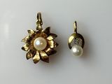 pair of pearl and gold flower earrings on a white surface