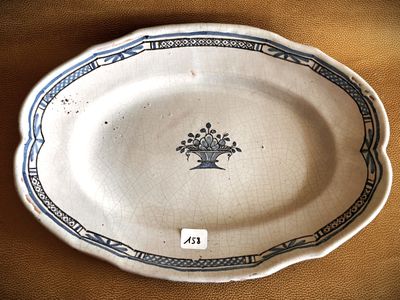 a white plate with a blue border and a flower design on it