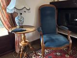 a chair and a table in a room with a fireplace