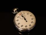 a close up of a stopwatch on a black surface