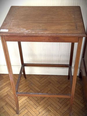 a small wooden table with a wooden top on a hard wood floor