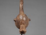 a close up of a sculpture of a bird on a stand