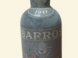 a bottle of liquor sitting next to a glass of wine