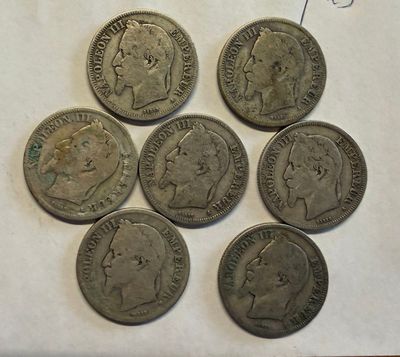 six different types of coins on a piece of paper on a table