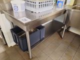 a stainless steel table with a basket on top of it