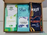 three bags of coffee in a box on a table