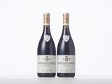two bottles of wine sitting next to each other on a table