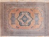 a rug hanging on a brick wall in a room