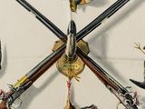 many different types of guns hanging from the ceiling