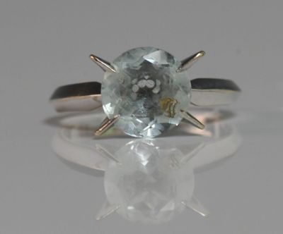 an image of a ring with a blue topazt stone