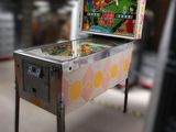 a pinball machine sitting on a table in a room