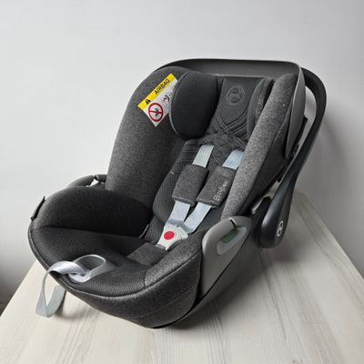 a baby car seat on a table in a room