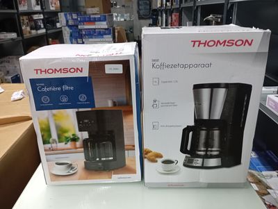 two boxes of coffee makers on a table in a store