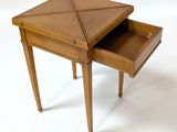 a small wooden table with a drawer on it