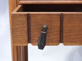 a drawer that has a black handle on it