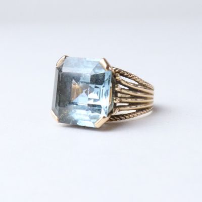 an image of a ring with a blue topaz stone