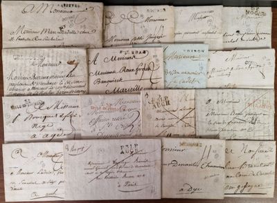 several old letters are stacked on top of each other on a table