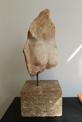 a stone sculpture of a head on top of a table