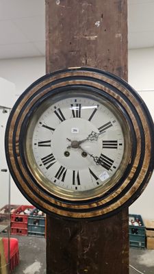 a clock that is on a wooden pole in a room
