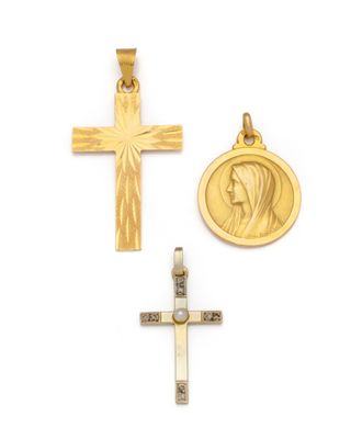 two gold crosses and a medal on a white background