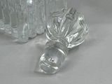a glass vase and a glass salt shaker on a table