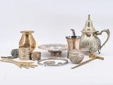 a lot of silver and gold items on a white surface