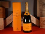a bottle of champagne sitting next to a box of wine