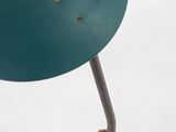 an image of a green lamp on a metal stand on a white surface