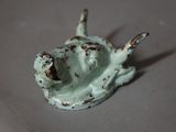 a small figurine of a dog that is sitting on a table
