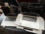 two laptops that are sitting on top of a desk